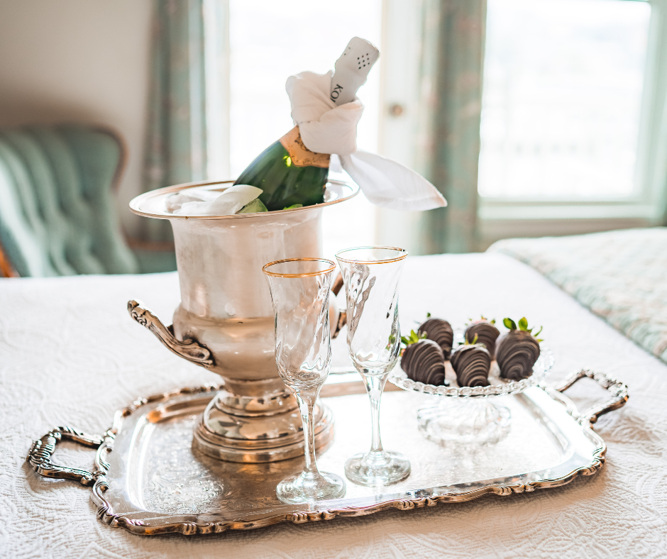 champagne and strawberries on bed